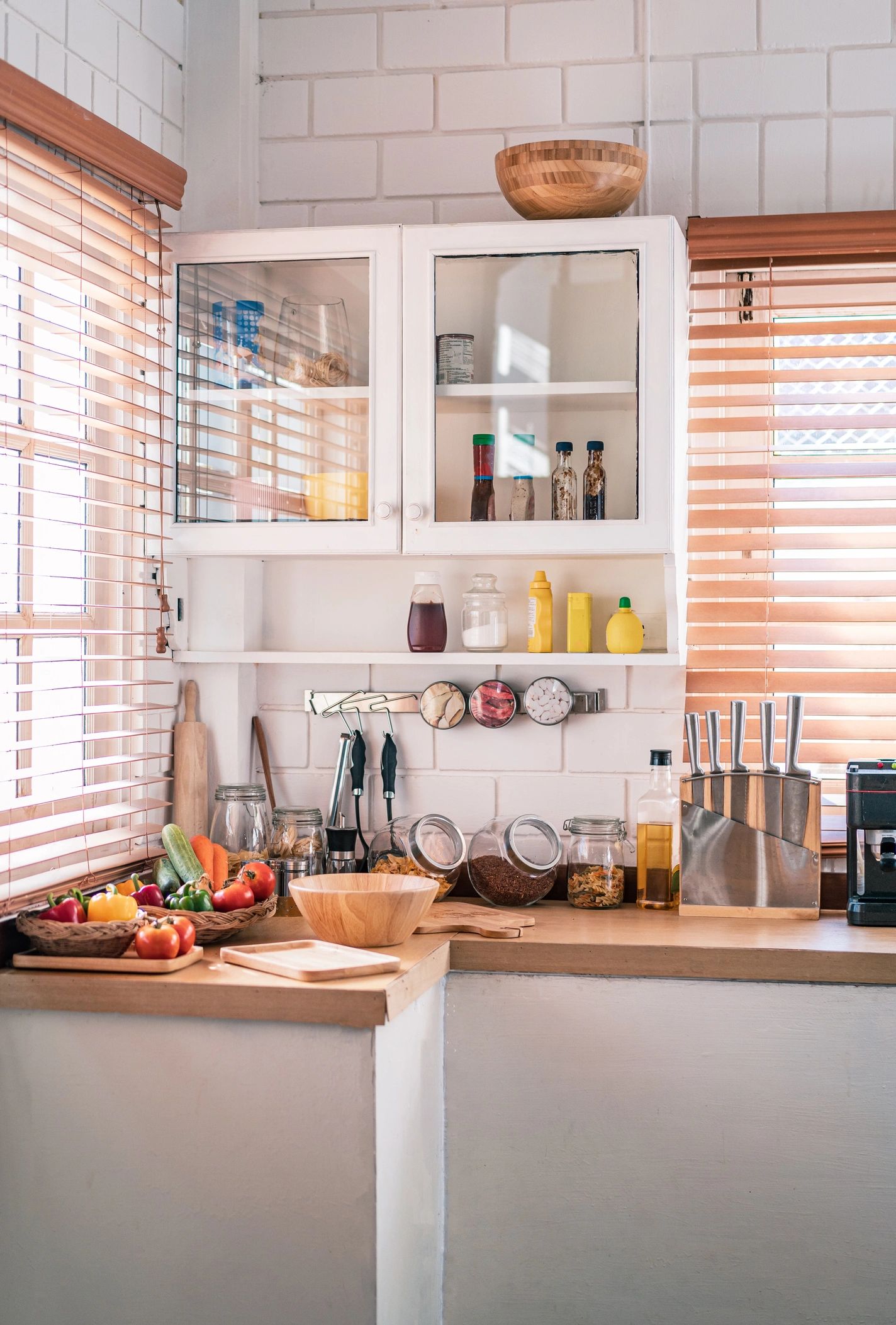 Bright organized kitchen with fresh vegetables and sunlight