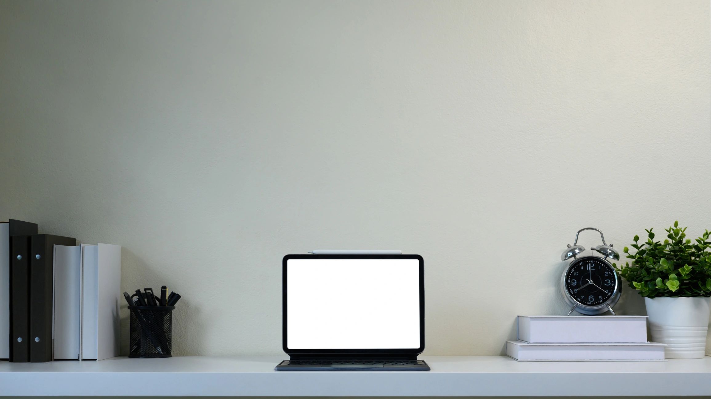 Modern workspace with digital tablet on a calm white desk