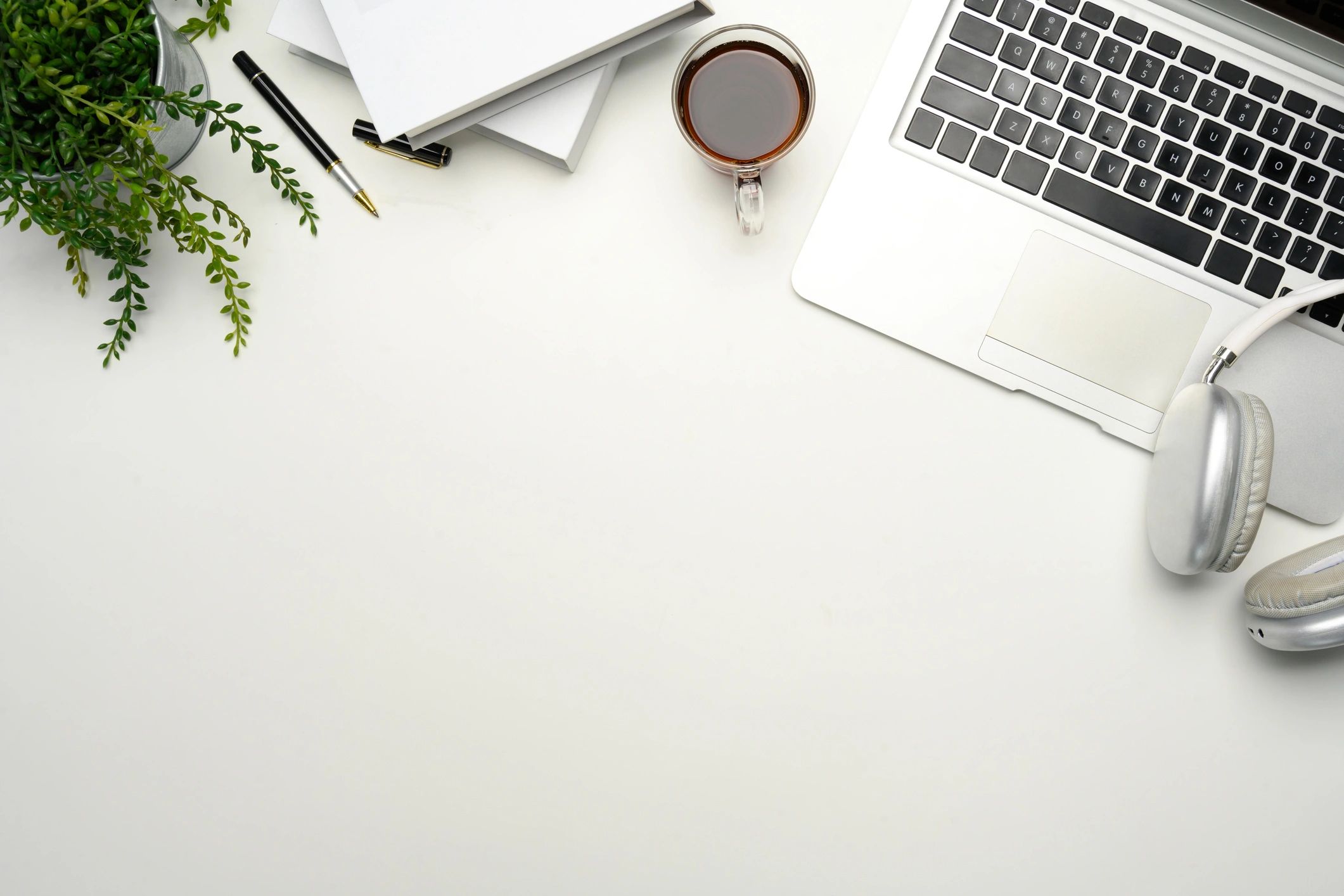 Minimal planner workspace with notebook and coffee on a clean desk