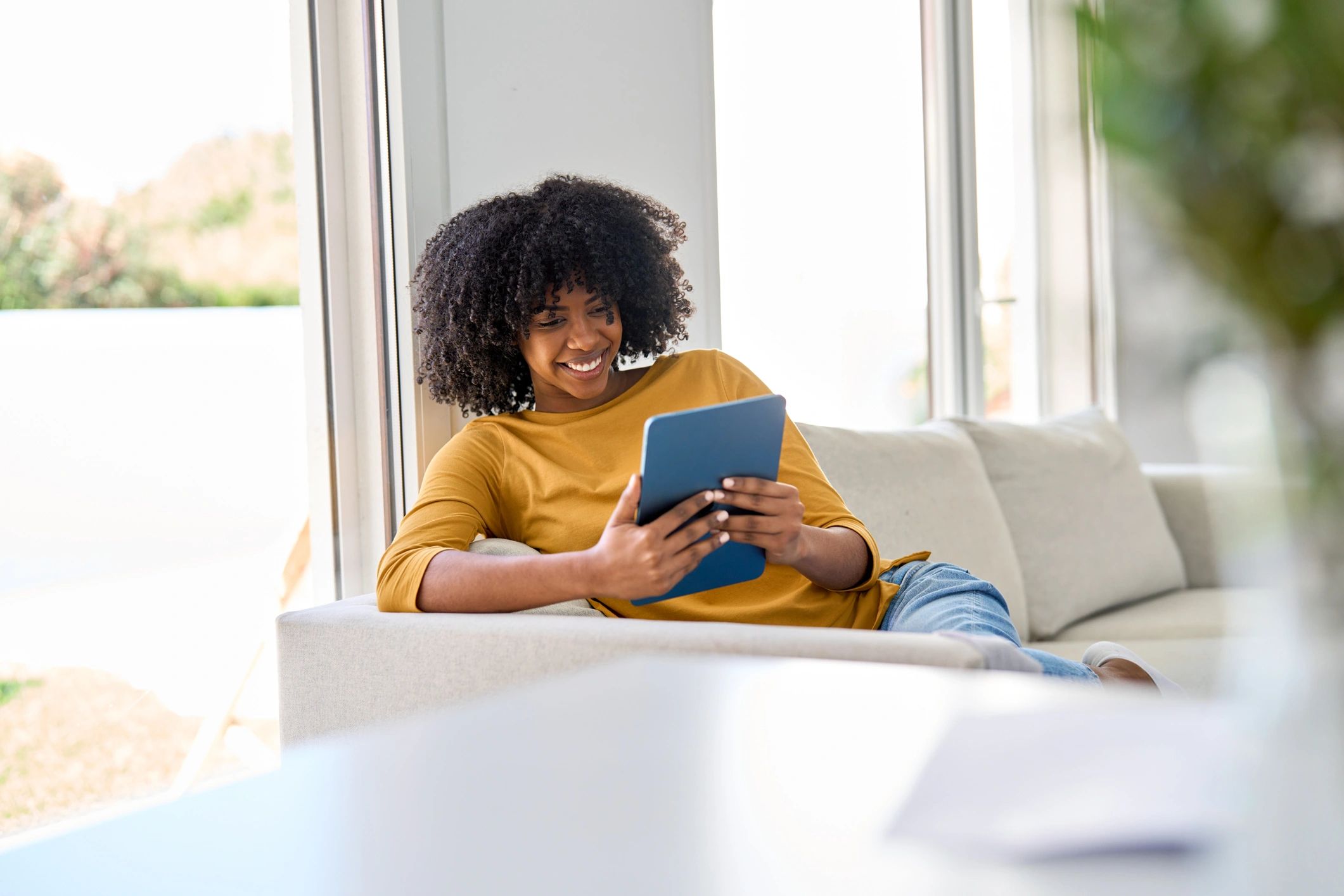 Customer relaxing at home with a tablet