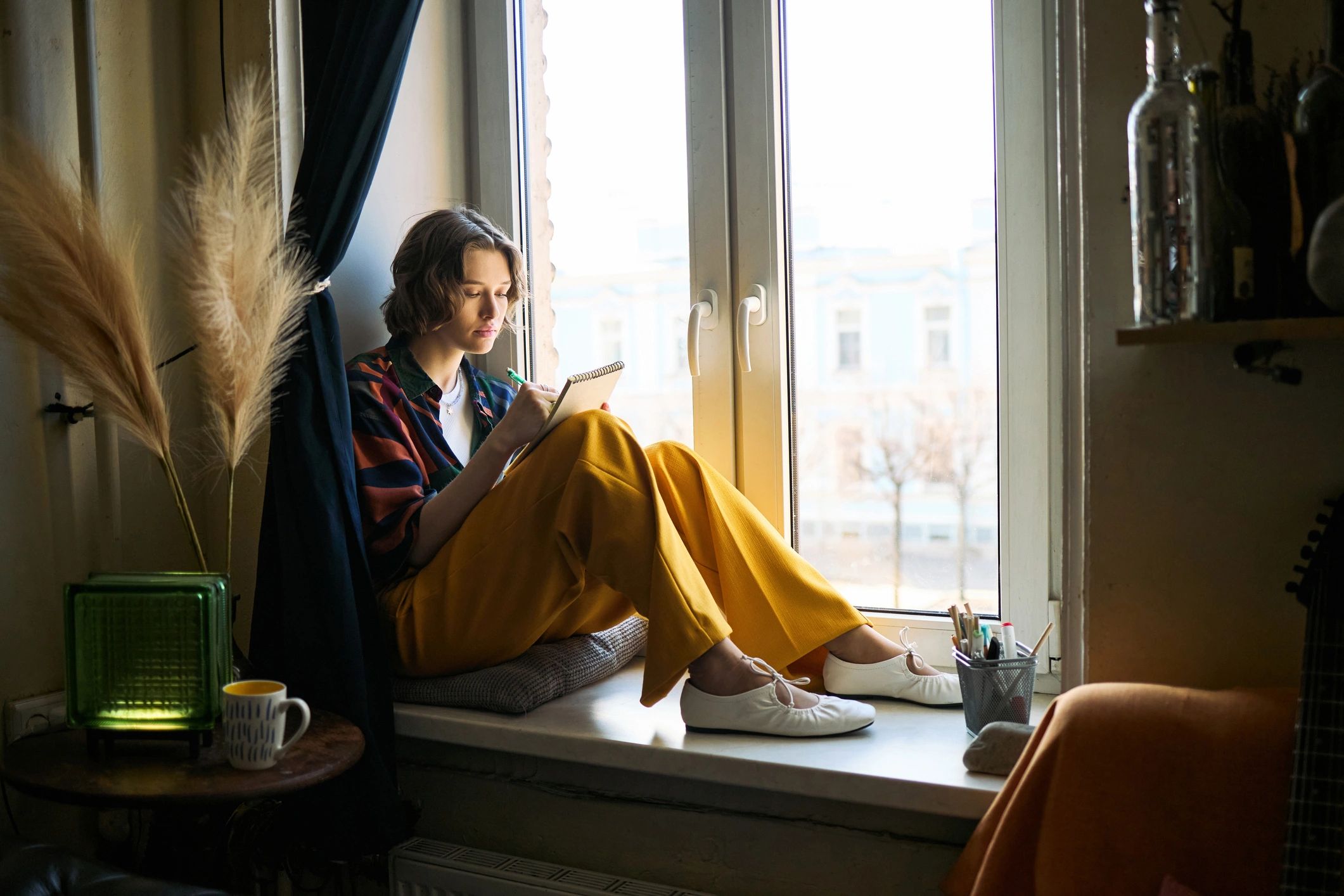 Woman journaling in a peaceful setting for intentional planning